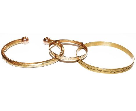 A 9 carat gold baby's bangle, a bangle stamped '375' (a.f.) and a 9 carat gold torque bangle.  Gross weight 19.5 grams. 
