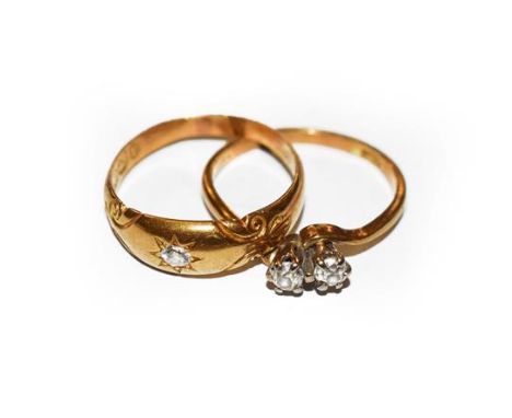 An 18 carat gold diamond solitaire ring, finger size M; and a diamond two stone twist ring, stamped '18CT', finger size L.  G