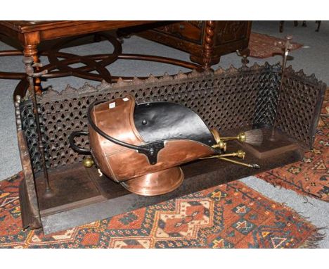 A Victorian pierced cast iron fire fender, together with brass fire tools, a blow lamp and a copper coal scuttle 
