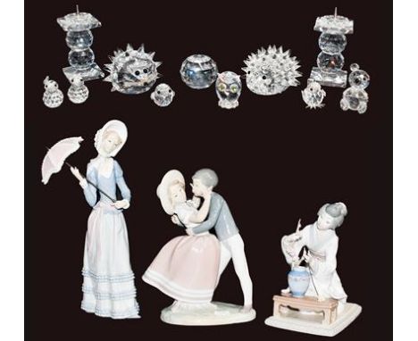 Three Lladro figures including a Geisha, a quantity of Swarovski crystal animals, and a pair of candlesticks, some boxed (one