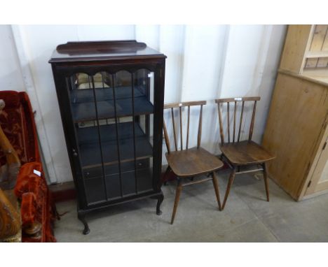 A pair of Ercol dark elm and beech chairs, a bookcase and one other 