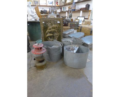A brass fire screen, three galvanised mop buckets and a Tilley lamp 