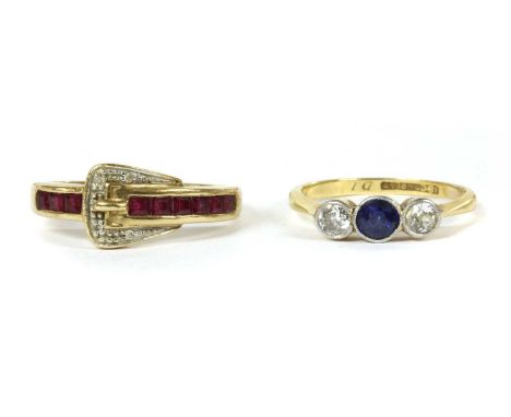 A gold sapphire and diamond three stone ring, a round mixed cut sapphire with an old European cut diamond each side, millegra