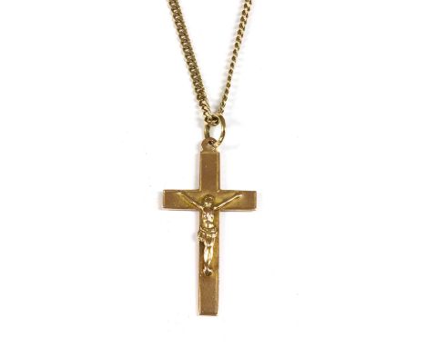 A 9ct rose gold crucifix, Chester 1938, with split ring jump ring, suspended from a 9ct gold curb chain, 475mm long, 8.32gCon