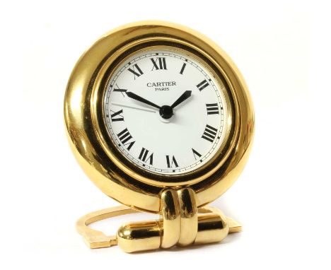 A Must de Cartier 'Colisee' quartz travel alarm clock, c.1993, white enamel dial with Roman numerals, to gilt metal case with