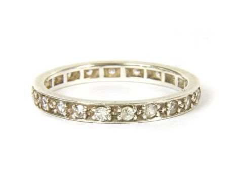 A white gold diamond full eternity ring, with a row of eight cut diamonds, grain set to plain guards, tested as approximately