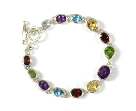 A sterling silver assorted gemstone bracelet, a graduated row of oval and pear shaped mixed cut garnet, citrine, peridot, blu