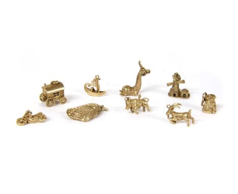 A quantity of gold charms, to include a windmill, a goat, a bull, a caravan, a hinged vardo opening to reveal a fortune telle