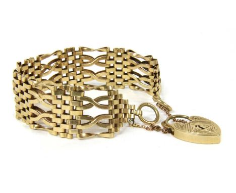 A 9ct gold gate bracelet, with crossover links and outer twisted bar links, to heart shaped padlock clasp and safety chain, L