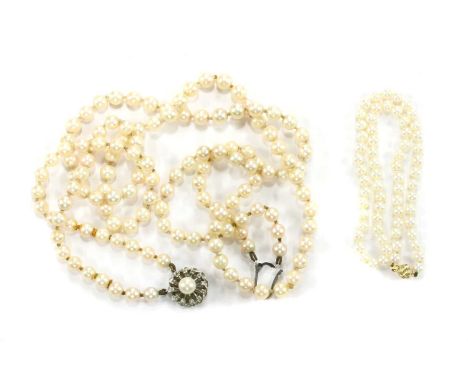 A two row slightly graduated cultured pearl necklace, 7 to 8mm in size, strung knotted to a 9ct white gold pearl and diamond 