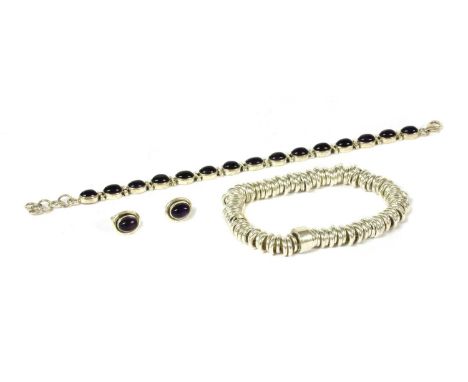 A sterling silver amethyst bracelet, with a row of oval cabochon amethyst, rub set, to trigger clasp, 200mm long, together wi