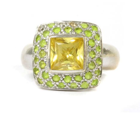 A white gold dress ring, yellow cubic zirconia rub set to two row halo of green gemstones, possibly prehnite, to tapering sha