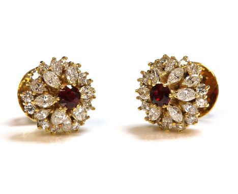 A pair of gold ruby and diamond cluster earrings, with a circular mixed cut ruby, claw set to the centre, to border of two st