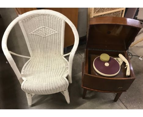 A Pye walnut record player on stand and a wicker armchair 