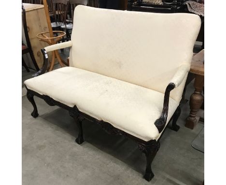 An early 20th Century Chippendale style carved mahogany and fabric upholstered settee 