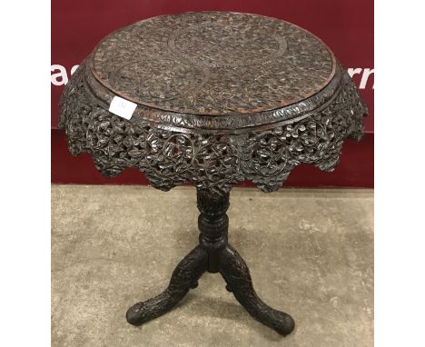 A late 19th Century Burmese carved hardwood tripod occasional table 