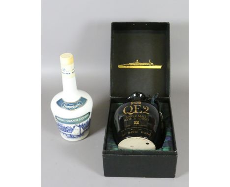 A box of commemorative single malt Scotch Whiskey for the QE2, along with a bottle of Nassau orange liqueur.