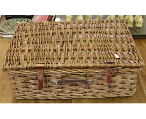 A vintage wicker picnic hamper and contents.