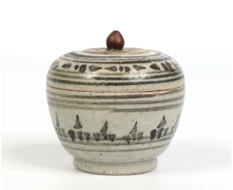 An antique Eastern lidded earthenware pot and cover decorated in underglaze blue, 9cm. Condition Report. To be used as a guid