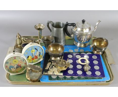 A tray of collectable metalwares to include 1970s World Cup coins, babies teething rattle, brass marching compass, sundial co