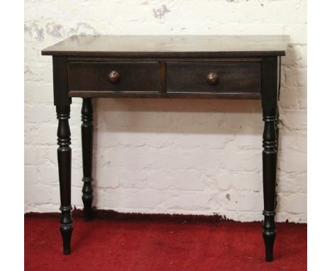 An early Victorian mahogany two drawer side table raised on turned supports.