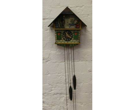 A carved and painted cased cuckoo clock lacking pendulum.