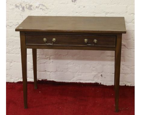 A mahogany single drawer side table raised on square tapering supports.