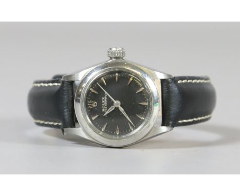 A ladies Rolex stainless steel oyster perpetual automatic wristwatch with centre seconds and black dial with arrow head marke