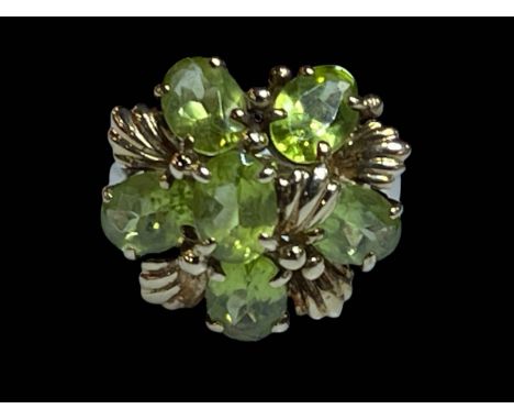Peridot six stone 9 carat gold ring, size N.