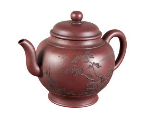 A CHINESE YIXING TEAPOT bearing a six character Qianlong seal mark to the base, of bulbous shape, decorated in relief with pa