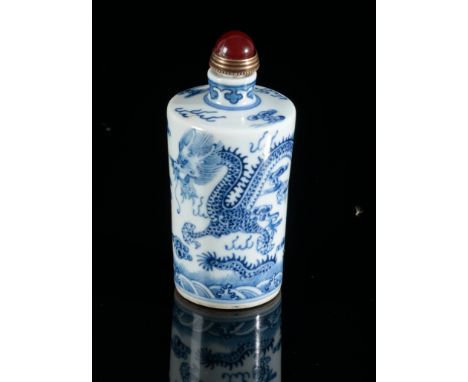 A CHINESE PORCELAIN BLUE AND WHITE SNUFF BOTTLEbearing a four character Qianlong mark to the base, decorated with dragons in 