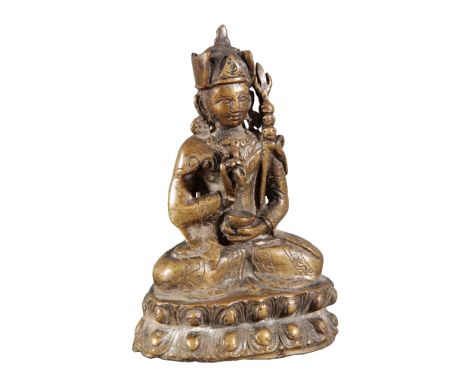 A TIBETAN BRONZE FIGURE OF BUDDHA probably late Ming dynasty, seated in dhyanasana on a double lotus throne, holding a vajra 