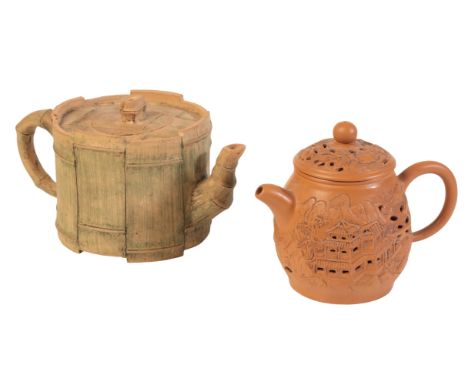 A CHINESE YIXING 'DOUBLE WALL' TEAPOT20th century, bearing a seal mark to the base, 10.5cm high; together with another simila