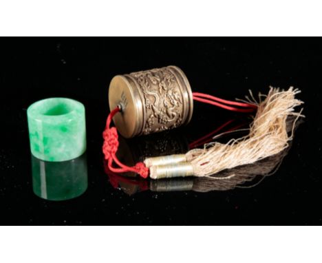 A CHINESE JADE ARCHER'S RINGin pale apple green jadeite, 2.5cm high x 3cm diameter; together with a gilt metal case, bearing 
