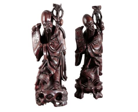 A PAIR OF CHINESE CARVED WOOD FIGURES OF SHOULAO 20th century, figured holding a staff and an open scroll, a crane seated at 