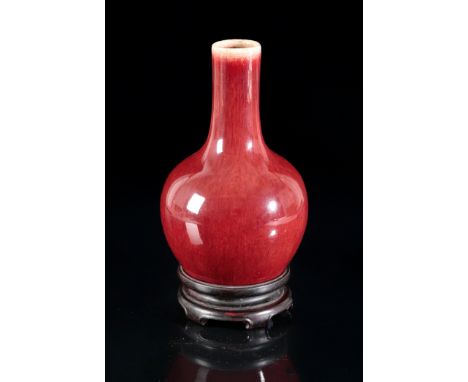 A CHINESE PORCELAIN FLAMBE GLAZED BOTTLE VASE probably Qianlong period, the rich red glaze lightly mottled, 17.5cm high, with