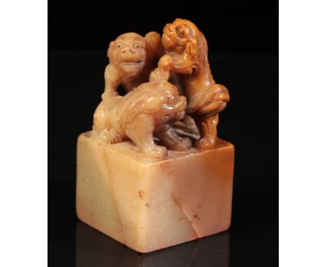 A CHINESE SOAPSTONE 'MYTHICAL BEASTS' SEAL attributable to Yang Yuxuan, Qing dynasty, the three beasts carved with bulbous ey