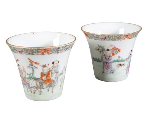 A PAIR OF CHINESE PORCELAIN FAMILLE ROSE CUPS19th/20th century, each bearing four character seal marks to the base, decorated