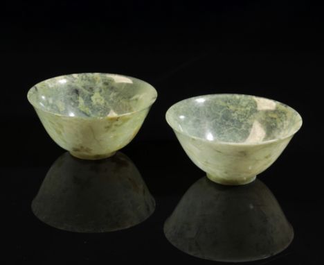 A PAIR OF CHINESE JADE BOWLS probably 20th century, with slightly flared rims and circular foots, 4.5cm high x 10cm diameter 