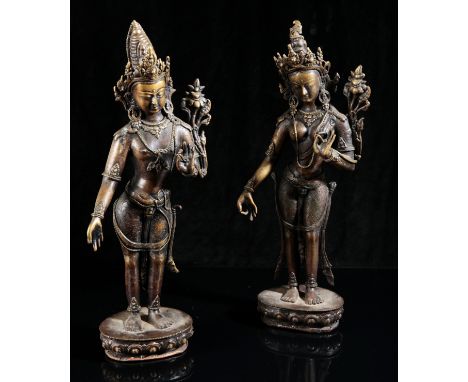 A NEAR PAIR OF NEPALESE BRONZE FIGURES OF TARA20th century, both cast standing on a single lotus base, with hands raised in v