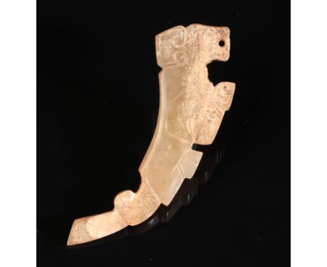 A CHINESE JADE 'TIGER' PENDANT possibly Shang or Western Zhou period, carved in a stylised form with incised features, 7cm lo