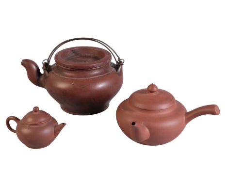 A GROUP OF THREE CHINESE YIXING TEAPOTS including a large teapot, with two double gourd marks to the lid, 10.5cm high, one wi