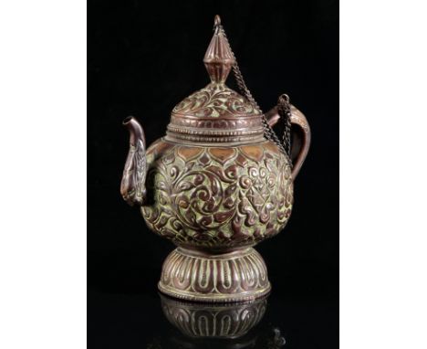 A TIBETAN BRONZE EWERlate 19th/early 20th century, embossed with abundant floral decoration to the body, 19cm high