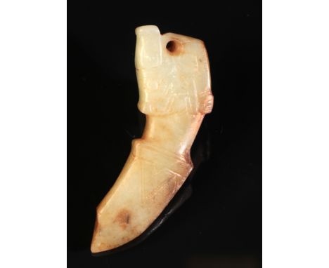 A CHINESE JADE PENDANT possibly Shang or Western Zhou period, of stylised form with incised decoration, 6.1cm long, in a fitt
