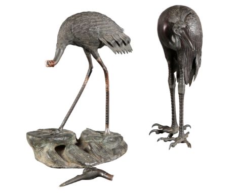 TWO SIMILAR JAPANESE BRONZE CRANES Meiji period, one figured striding on a naturistically cast base, 37cm high, the other wit