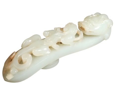 A CHINESE JADE BELT HOOK Qing dynasty, carved with a chilong beneath a dragons head finial, 13.5cm longProvenance: The collec