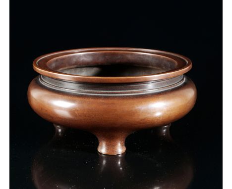A CHINESE BRONZE CENSERbearing a six character Xuande mark to the base, probably Qing dynasty, with a turned rim on tripod ba