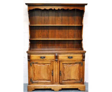 Edwardian oak dresser, canopy above a two shelf panel back, drawer and cupboard below, bracket feet, height 199cms, width 136