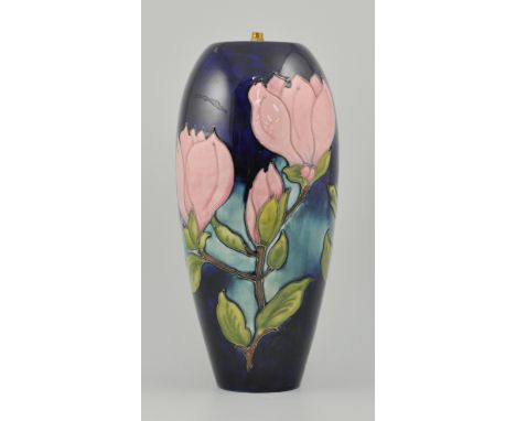 Walter Moorcroft: A large Moorcroft lamp base, Magnolia pattern, navy ground, height 39cms.