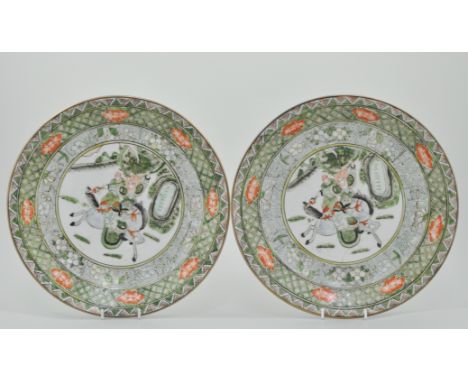 Pair of Chinese Famille Verte chargers, decorated with oriental hunting scenes, with a floral border, Chen Ling marks, diamet
